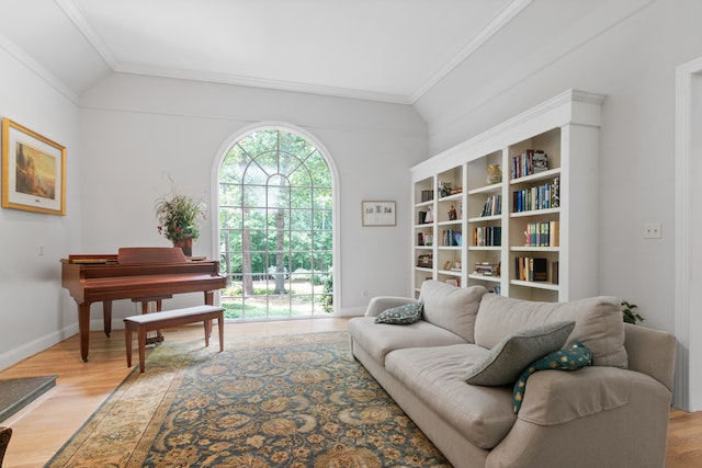 living room with a large picture window, white bookcase, and a brown piano